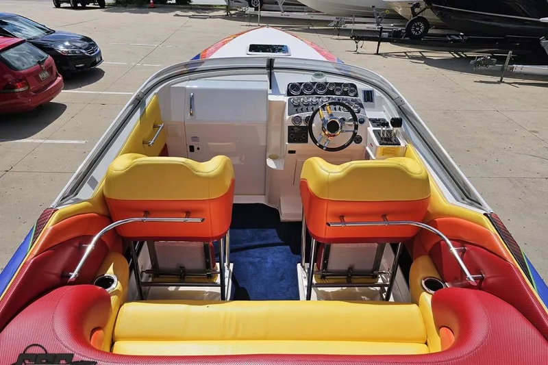 Slide: The Image of 1995 Wellcraft 29 Scarab boat interior with vibrant red and yellow seating. - 43