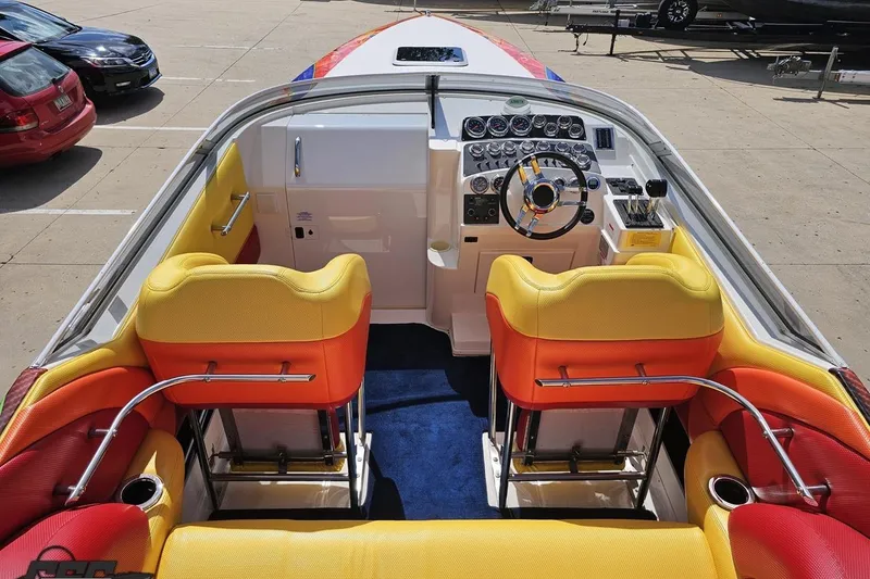 Slide: The Image of 1995 Wellcraft 29 Scarab boat interior with vibrant yellow and red seating. - 44