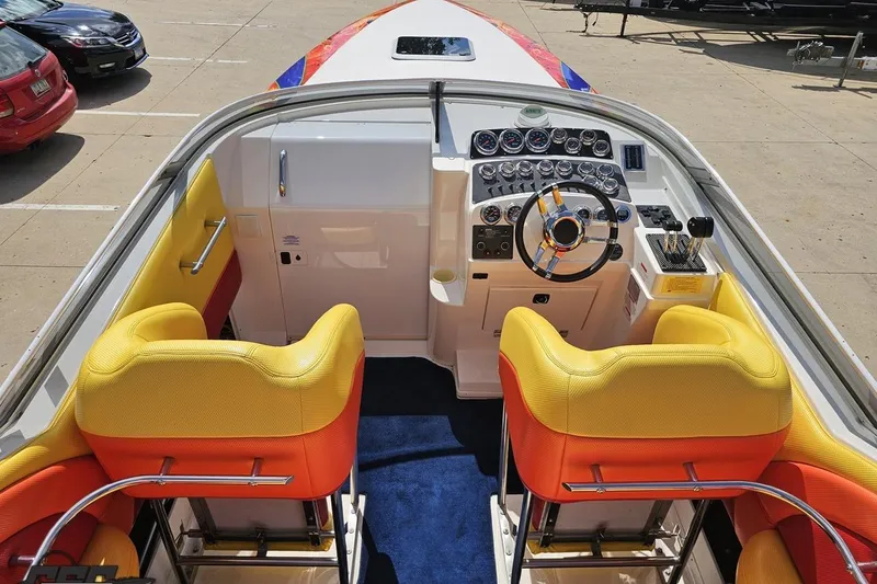 Slide: The Image of 1995 Wellcraft 29 Scarab boat interior with vibrant yellow and orange seats, detailed dashboard. - 45