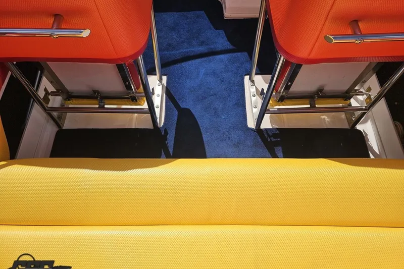Slide: The Image of Interior of 1995 Wellcraft 29 Scarab with vibrant orange and yellow seating. - 48