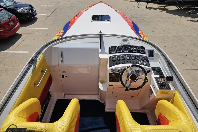 Slide: The Image of Interior view of 1995 Wellcraft 29 Scarab boat with vibrant seats and detailed dashboard. - 49