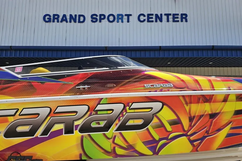 Slide: The Image of Colorful 1995 Wellcraft 29 Scarab boat at Grand Sport Center. - 5