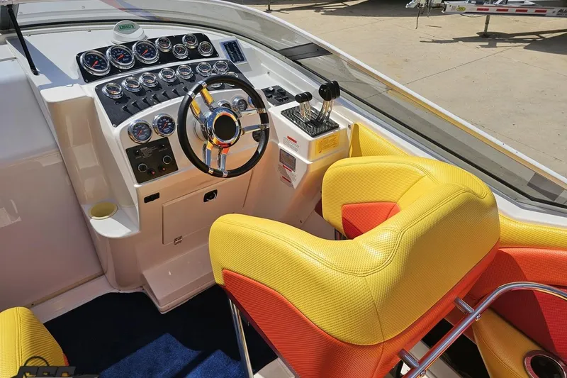 Slide: The Image of Interior of 1995 Wellcraft 29 Scarab boat with vibrant yellow and red seating. - 51