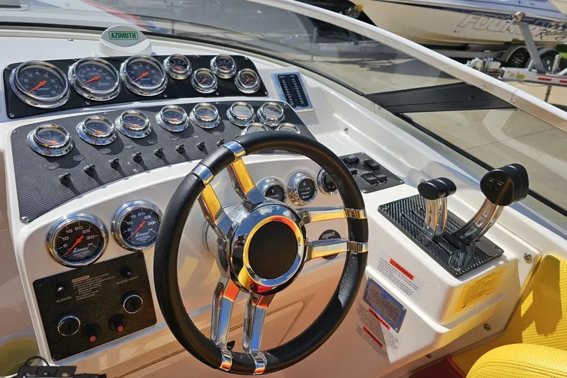 Slide: The Image of Control panel of a 1995 Wellcraft 29 Scarab boat with gauges and steering wheel. - 53
