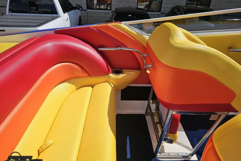 Slide: The Image of Colorful interior of a 1995 Wellcraft 29 Scarab boat with vibrant seating. - 54
