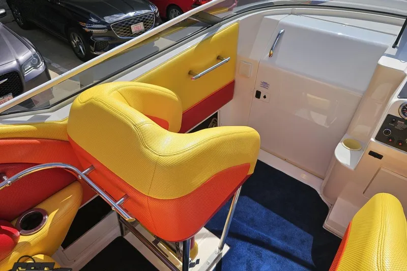 Slide: The Image of 1995 Wellcraft 29 Scarab interior with vibrant yellow and orange seating, sleek design. - 55