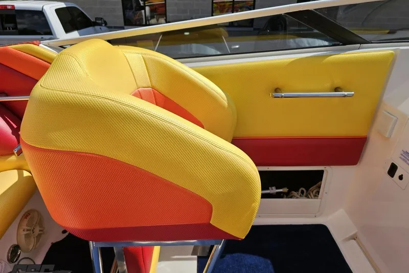 Slide: The Image of Colorful interior seating of a 1995 Wellcraft 29 Scarab boat, featuring vibrant yellow and red upholstery. - 56