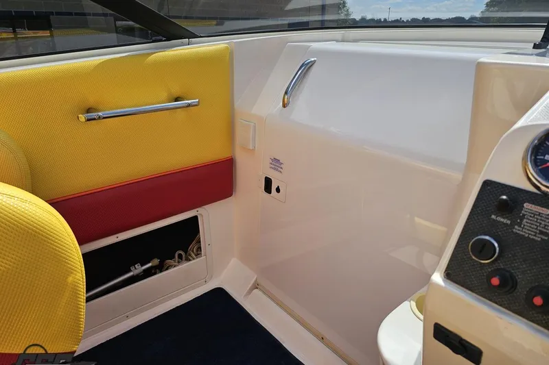 Slide: The Image of Interior of a 1995 Wellcraft 29 Scarab boat with yellow and red seating. - 57