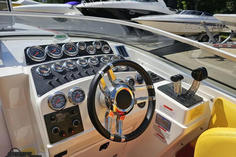 Slide: The Image of 1995 Wellcraft 29 Scarab boat dashboard with gauges and steering wheel. - 59