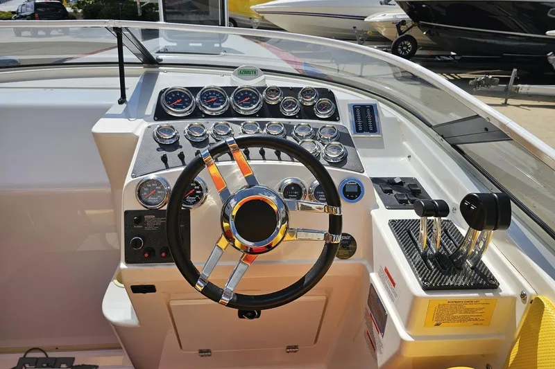 Slide: The Image of 1995 Wellcraft 29 Scarab boat dashboard with steering wheel and control gauges. - 60