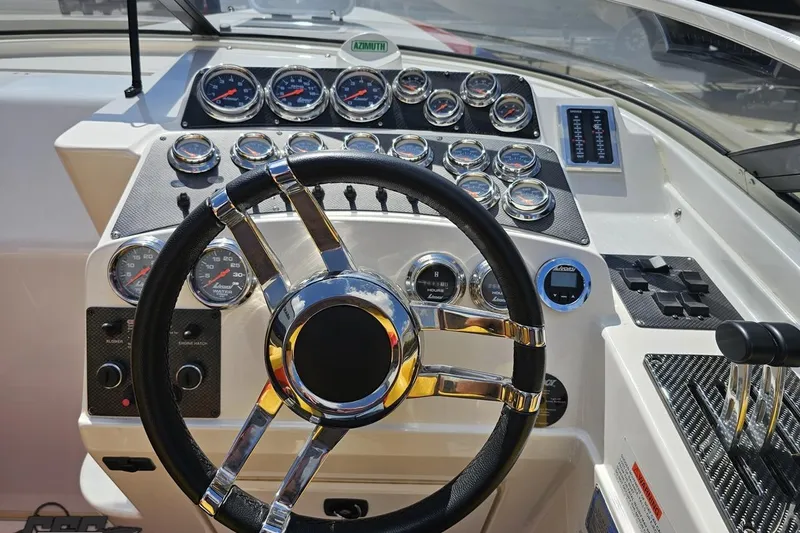 Slide: The Image of Steering wheel and dashboard of 1995 Wellcraft 29 Scarab boat with gauges and controls. - 61