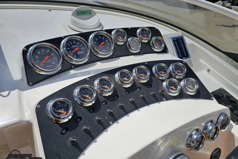 Slide: The Image of Dashboard of a 1995 Wellcraft 29 Scarab boat with multiple gauges and controls. - 63