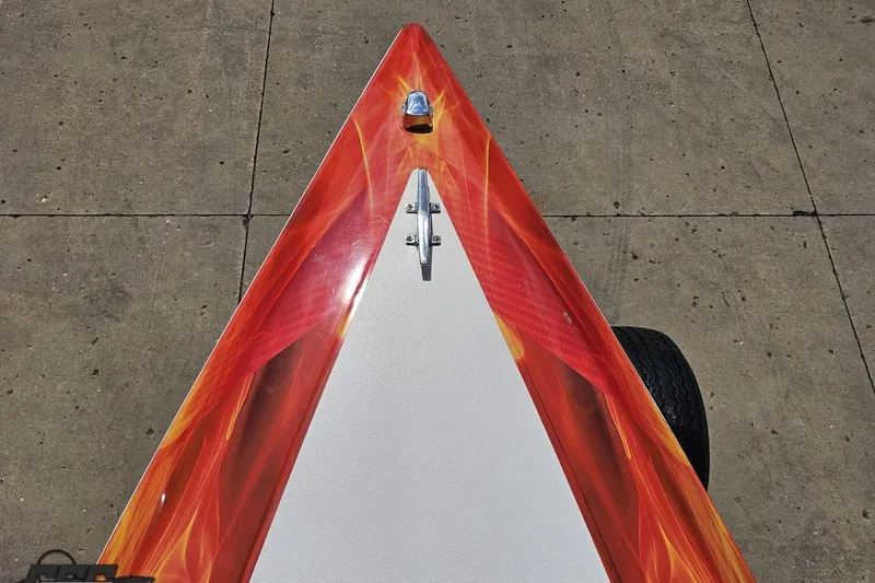Slide: The Image of Bow of 1995 Wellcraft 29 Scarab with vibrant red and orange design. - 69