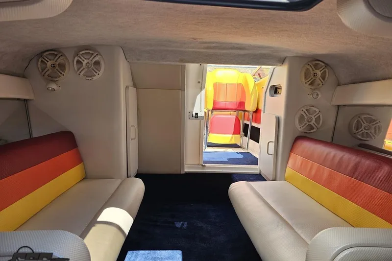 Slide: The Image of Interior of 1995 Wellcraft 29 Scarab boat with colorful seating and speakers. - 81