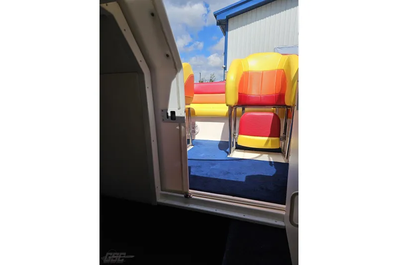 Slide: The Image of Interior view of 1995 Wellcraft 29 Scarab boat with vibrant seating and blue carpet. - 86