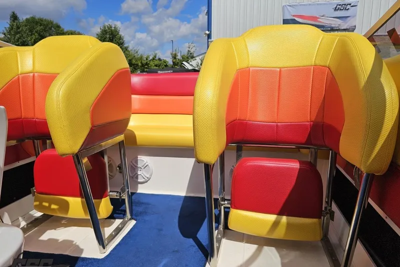 Slide: The Image of Colorful interior seating of a 1995 Wellcraft 29 Scarab boat under a sunny sky. - 88