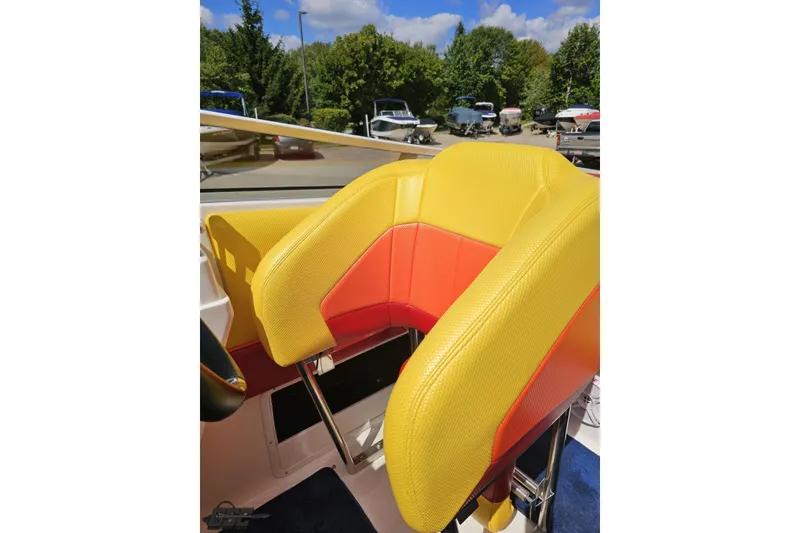 Slide: The Image of Yellow and red seats on 1995 Wellcraft 29 Scarab boat, with outdoor background. - 90