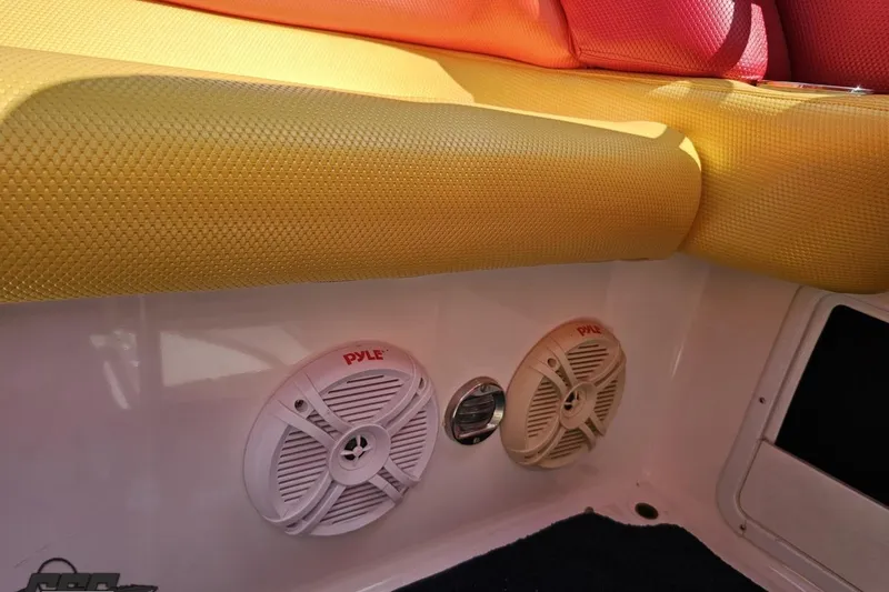 Slide: The Image of Interior of 1995 Wellcraft 29 Scarab with colorful seating and Pyle speakers. - 93