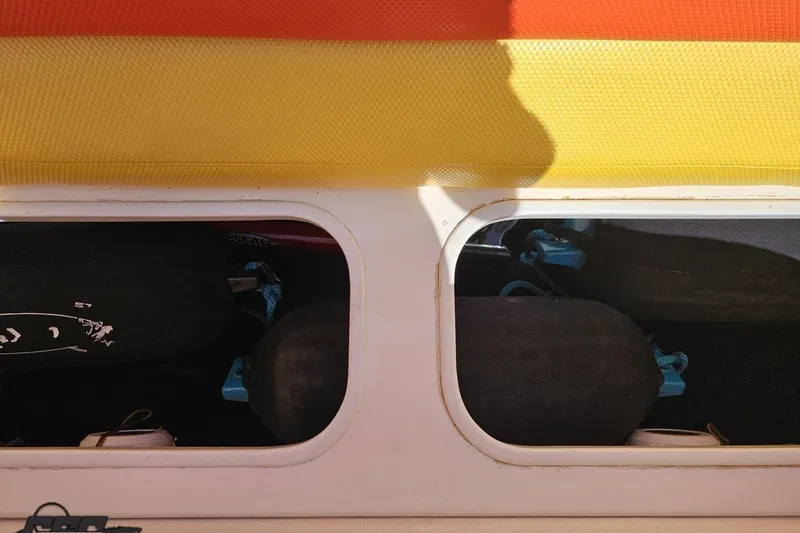 Slide: The Image of Storage compartment of a 1995 Wellcraft 29 Scarab boat with colorful cover. - 95