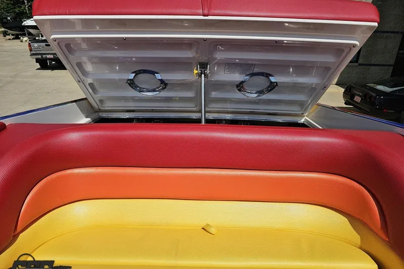 Slide: The Image of Colorful seating on a 1995 Wellcraft 29 Scarab boat with open storage compartments. - 96