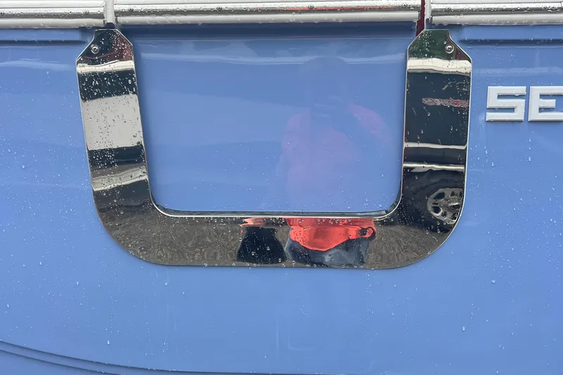 Slide: The Image of Close-up of 2025 Sea Fox 268c Commander boat with chrome detail and raindrops. - 14