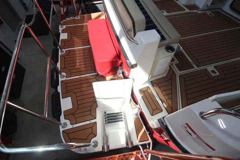 Slide: The Image of 2026 Ranger Tugs R-31 Command Bridge Luxury Edition deck with wood finish and seating. - 12