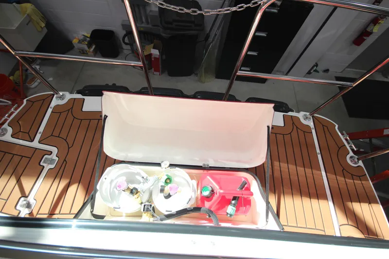 Slide: The Image of 2026 Ranger Tugs R-31 Command Bridge Luxury Edition deck with storage compartment open. - 14