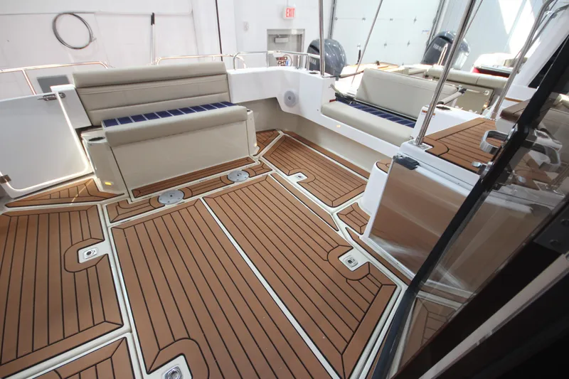 Slide: The Image of 2026 Ranger Tugs R-31 Command Bridge Luxury Edition with elegant teak flooring and seating. - 17