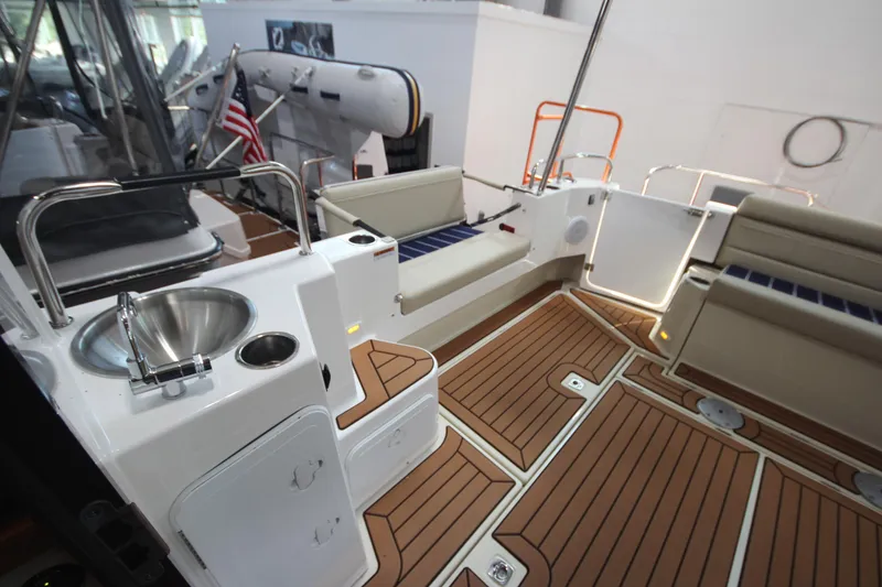 Slide: The Image of 2026 Ranger Tugs R-31 Command Bridge Luxury Edition, featuring elegant deck and seating area. - 18