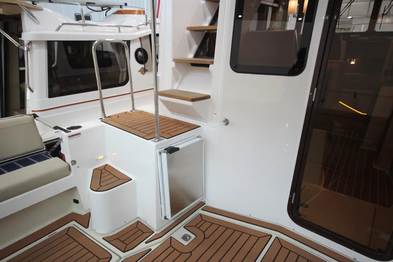 Slide: The Image of 2026 Ranger Tugs R-31 Command Bridge Luxury Edition interior with teak flooring and modern design. - 20