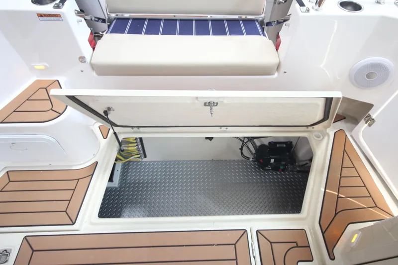 Slide: The Image of 2026 Ranger Tugs R-31 Command Bridge Luxury Edition, open storage compartment, teak flooring. - 22