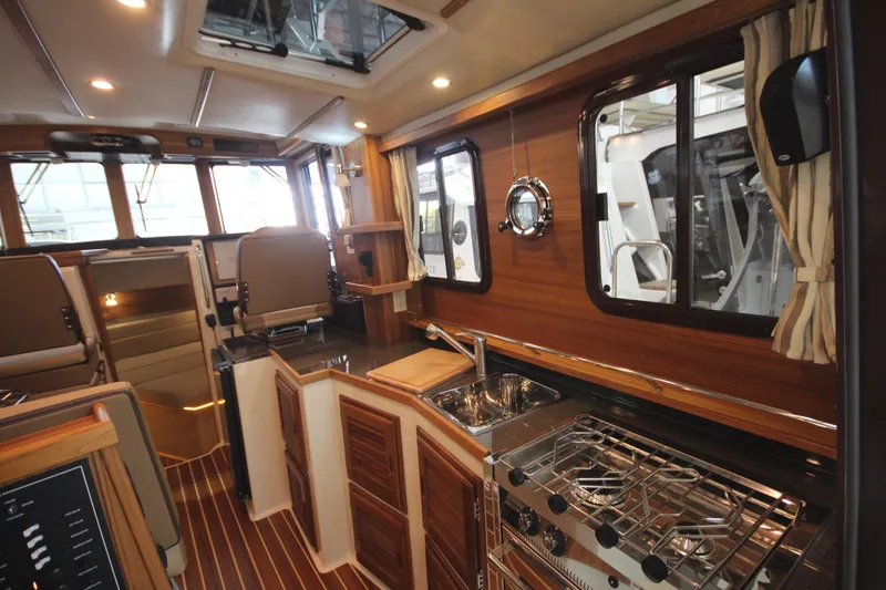 Slide: The Image of Luxurious interior of 2026 Ranger Tugs R-31 Command Bridge, featuring elegant wood finishes and modern amenities. - 26