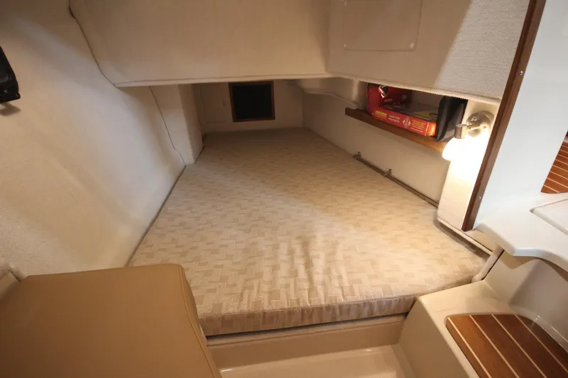 Slide: The Image of 2026 Ranger Tugs R-31 Command Bridge Luxury Edition cabin interior with cozy sleeping area. - 31
