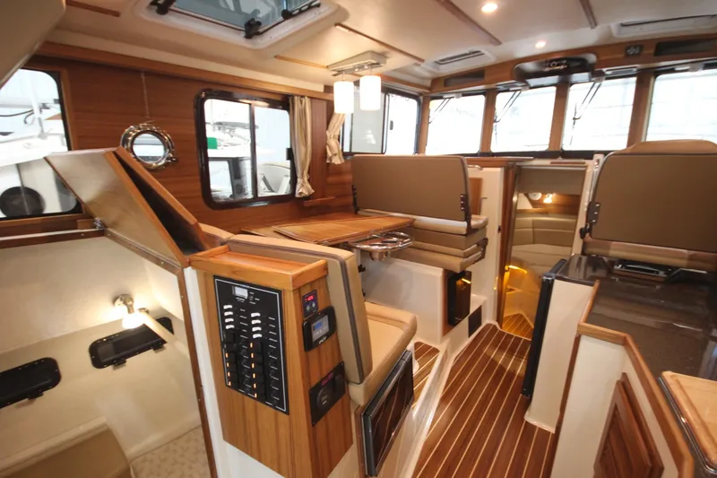 Slide: The Image of Interior of 2026 Ranger Tugs R-31 Command Bridge Luxury Edition, featuring elegant wood finishes. - 33