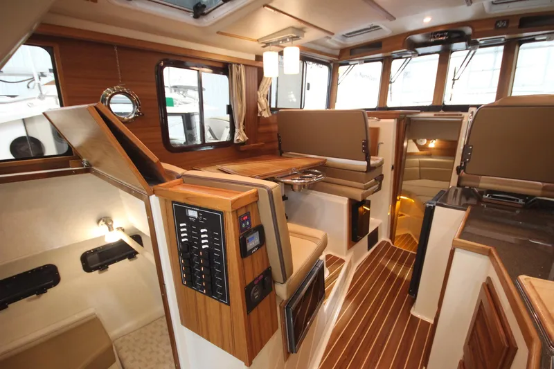 Slide: The Image of Interior of 2026 Ranger Tugs R-31 Command Bridge Luxury Edition, featuring elegant wood finishes. - 34