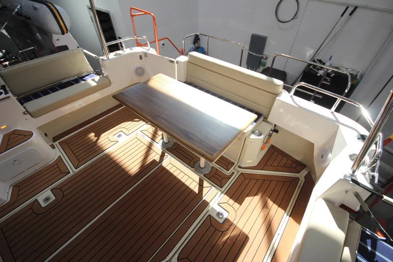 Slide: The Image of 2026 Ranger Tugs R-31 Command Bridge Luxury Edition cockpit with seating and wooden table. - 35