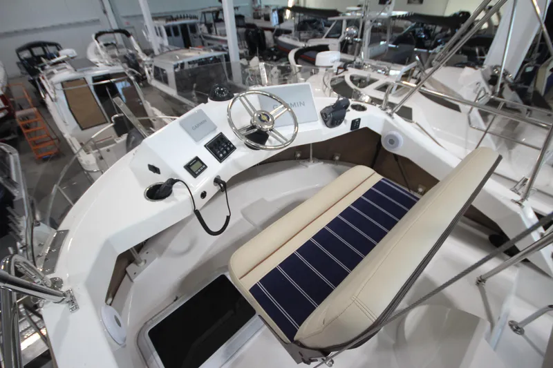 Slide: The Image of 2026 Ranger Tugs R-31 Command Bridge Luxury Edition helm with modern controls and seating. - 39