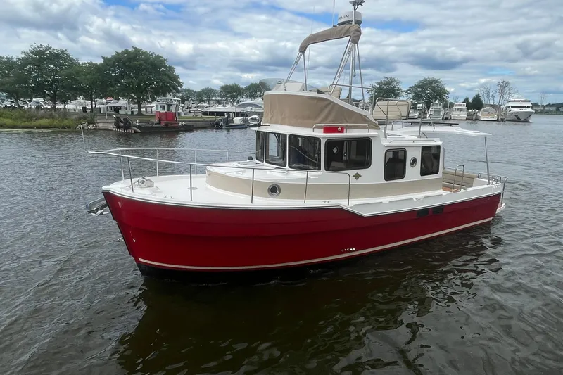 Slide: The Image of 2026 Ranger Tugs R-31 Command Bridge Luxury Edition on a serene waterway. - 4