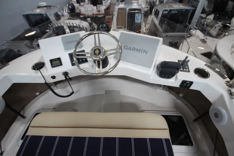 Slide: The Image of 2026 Ranger Tugs R-31 Command Bridge Luxury Edition helm with Garmin navigation system. - 40