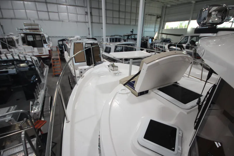 Slide: The Image of 2026 Ranger Tugs R-31 Command Bridge Luxury Edition in a showroom, showcasing sleek design. - 43