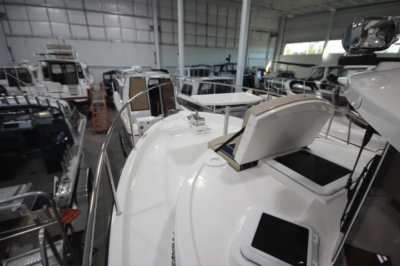 Slide: The Image of 2026 Ranger Tugs R-31 Command Bridge Luxury Edition in a showroom, showcasing sleek design. - 44