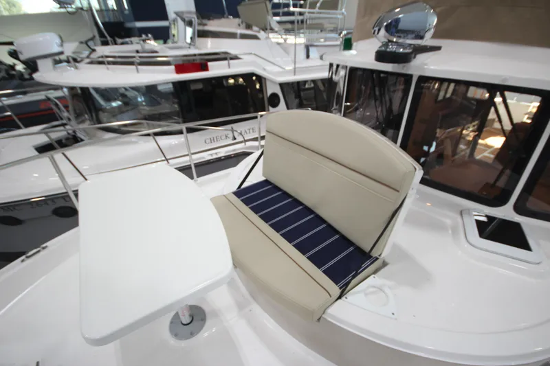 Slide: The Image of 2026 Ranger Tugs R-31 Command Bridge Luxury Edition with seating and table on deck. - 46