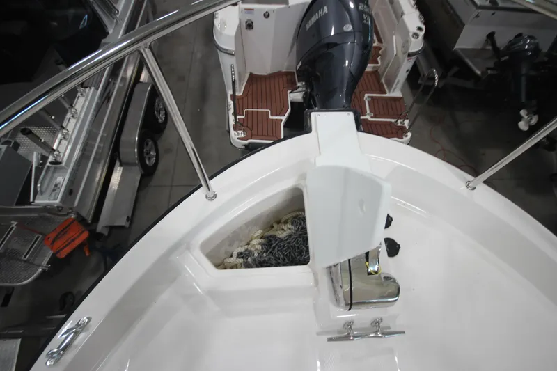 Slide: The Image of 2026 Ranger Tugs R-31 Command Bridge Luxury Edition boat deck with anchor and storage. - 48
