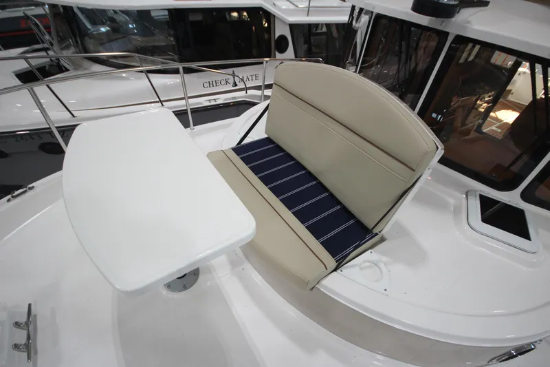Slide: The Image of 2026 Ranger Tugs R-31 Command Bridge Luxury Edition seating area with table. - 49