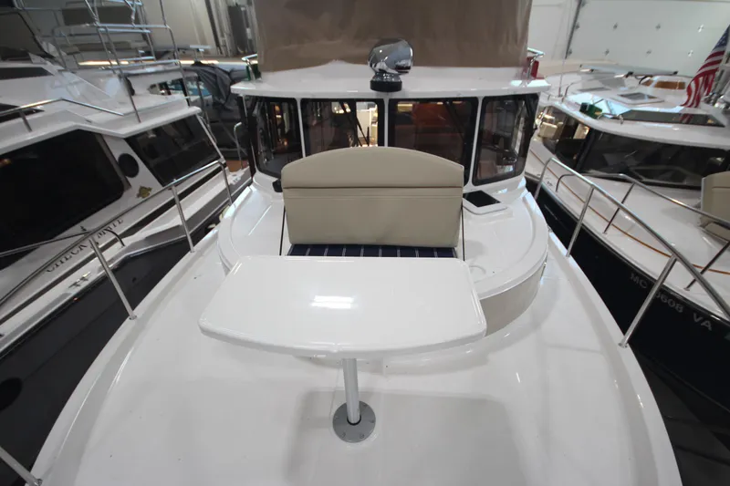 Slide: The Image of 2026 Ranger Tugs R-31 Command Bridge Luxury Edition yacht interior with seating and table. - 50