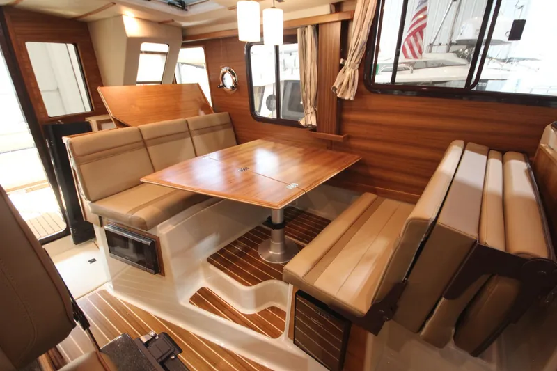 Slide: The Image of Luxurious interior of 2026 Ranger Tugs R-31 Command Bridge, featuring elegant wood and leather seating. - 52