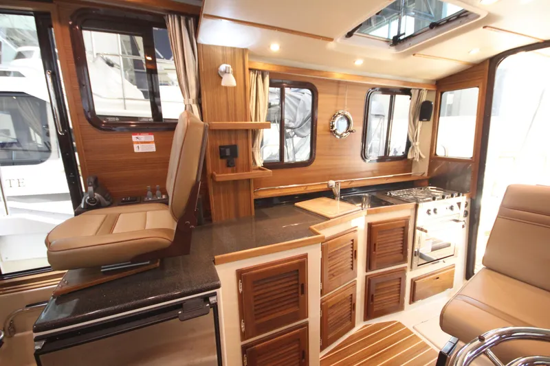 Slide: The Image of Luxurious interior of 2026 Ranger Tugs R-31 Command Bridge, featuring elegant wood finishes and modern amenities. - 53