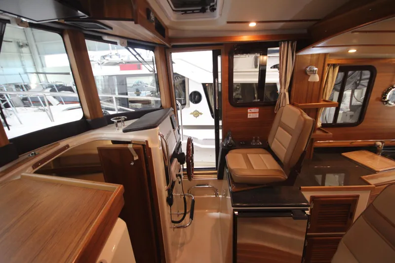Slide: The Image of Interior of 2026 Ranger Tugs R-31 Command Bridge Luxury Edition, featuring elegant wood finishes. - 57