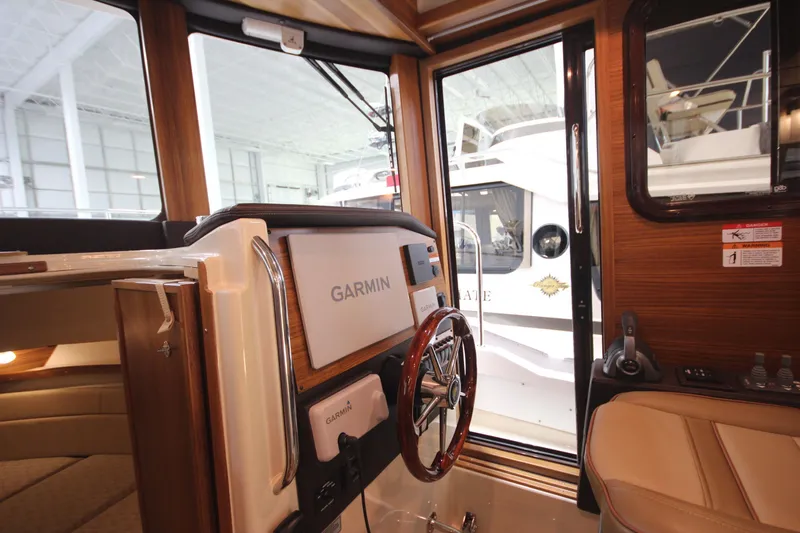Slide: The Image of Interior view of 2026 Ranger Tugs R-31 Command Bridge, featuring Garmin navigation system. - 58
