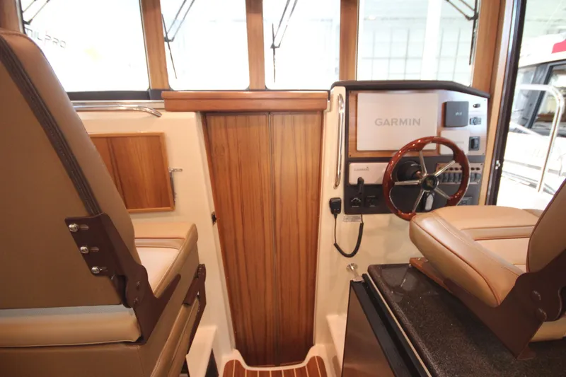 Slide: The Image of 2026 Ranger Tugs R-31 Command Bridge Luxury Edition interior with Garmin navigation system. - 61
